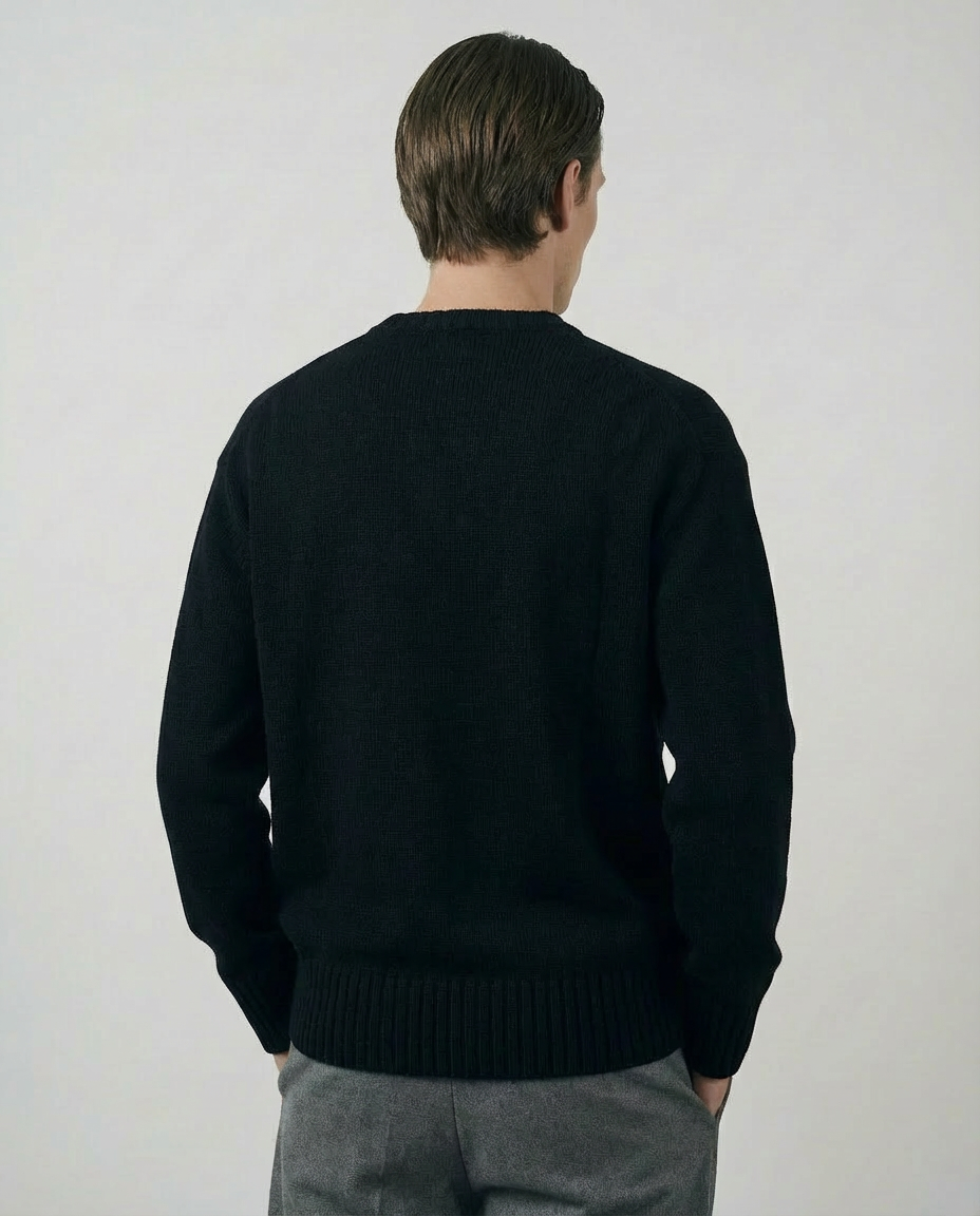 man wearing a dark black crewneck sweater made in italy casa nodale merino wool and cashmere