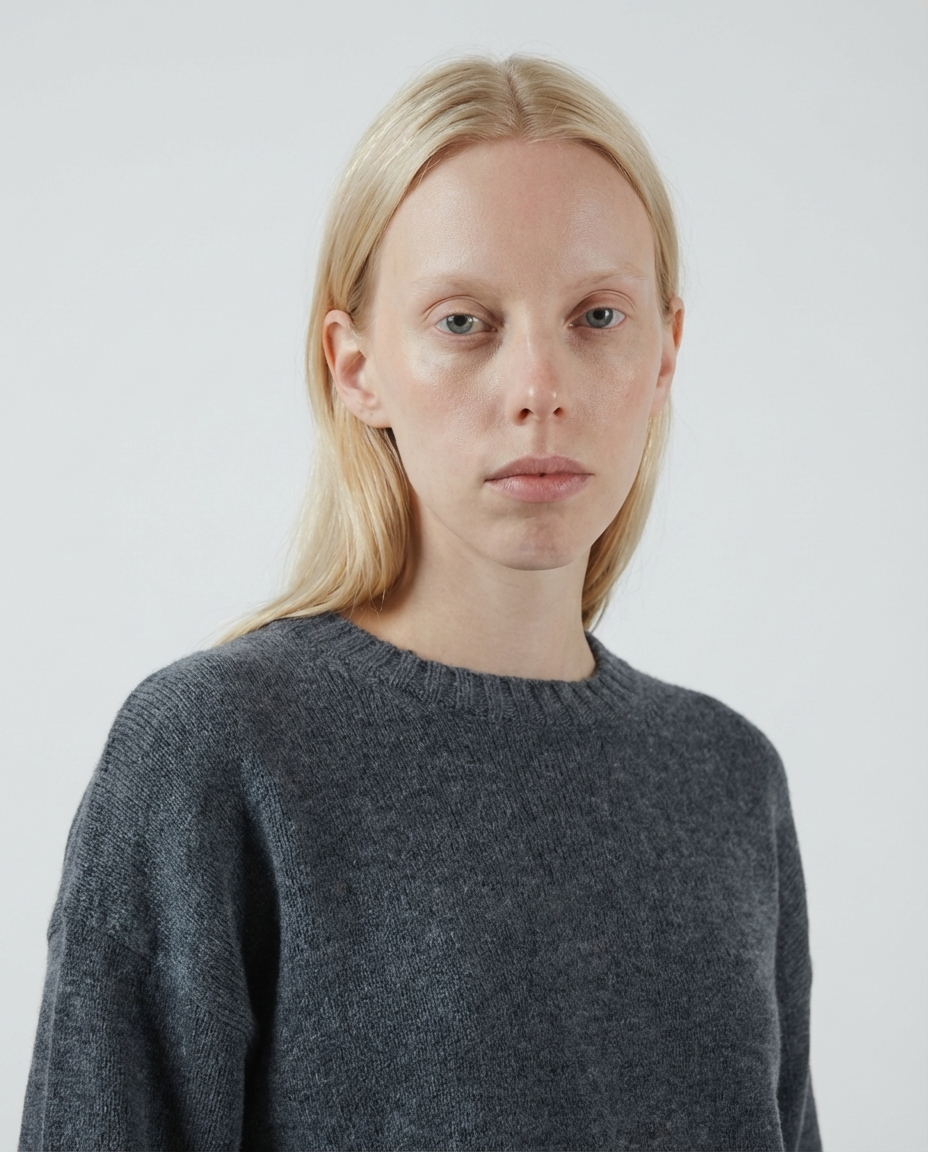 woman wearing a dark gray charcoal crewneck sweater made in italy casa nodale merino wool and cashmere