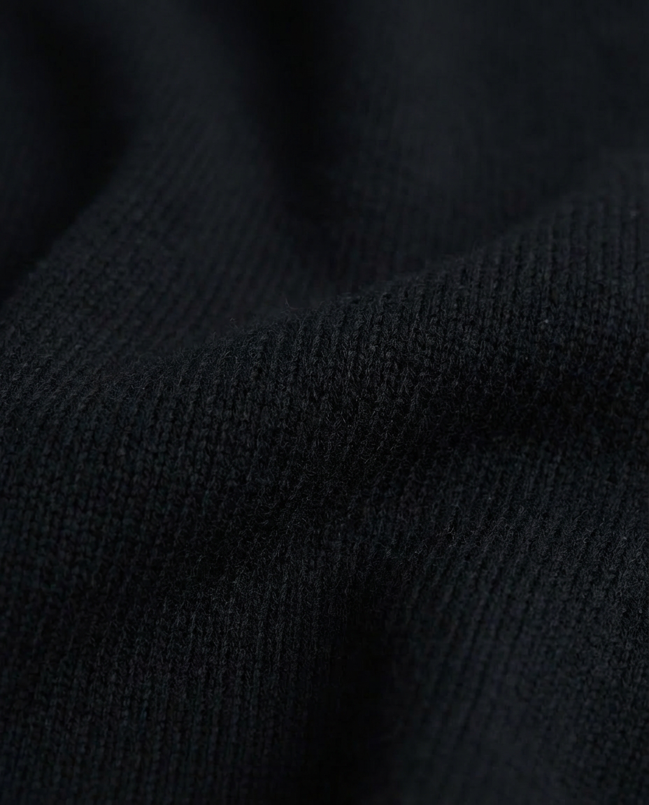 Close-up of black textured fabric dark black crewneck sweater made in italy casa nodale merino wool and cashmere